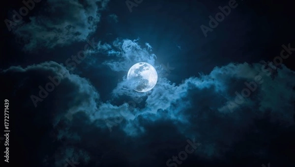 Fototapeta Photo of a nighttime sky with illuminated clouds and a large, bright full moon, ideal for editorial header background