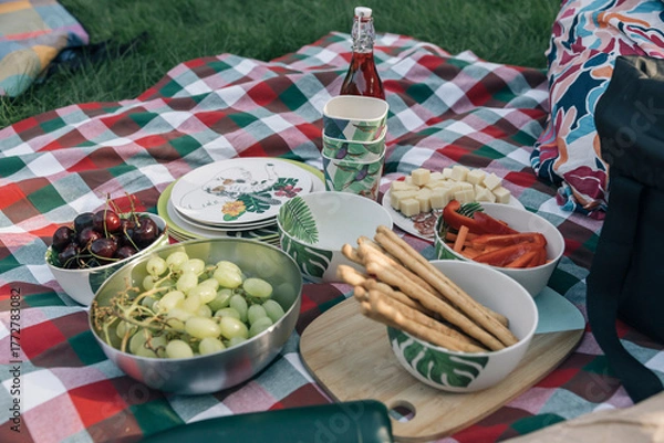 Fototapeta Picnic blanket with fresh fruit, vegetables and snacks