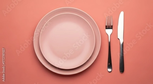 Fototapeta Salmon Color Table Setting: Plates, Fork, Knife on Colored Surface, Stylish Dining Arrangement, Modern Flat Lay Tableware Collection, Creative Minimalist Presentation