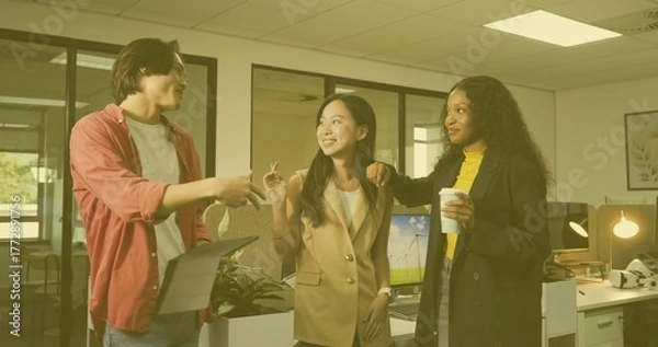Fototapeta Discussing three colleagues holding tablet keys and coffee cup in open-plan office, with monitors