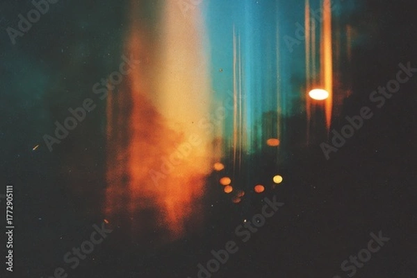 Obraz A blurry street light shining in the night with a vintage film grain effect, vertical light leaks, and subtle scratches.