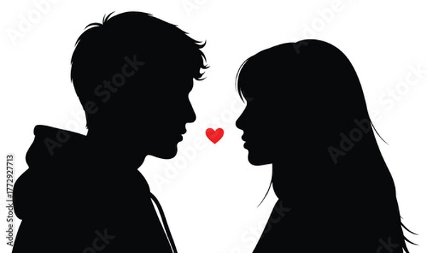Fototapeta Silhouette of a couple facing each other with a red heart between them