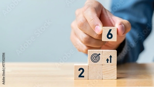 Fototapeta Hand placing wooden block with number 6 on stacked blocks with target and growth icons