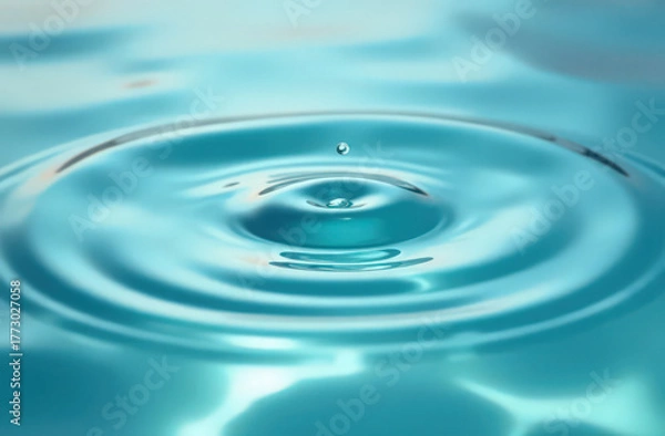 Obraz Water drop creating ripples on blue surface