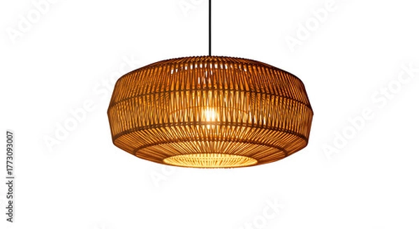 Fototapeta Warm glowing woven bamboo pendant light fixture hanging in darkness creating cozy atmosphere