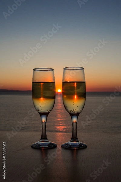Obraz Two glasses of wine at sunset on the table