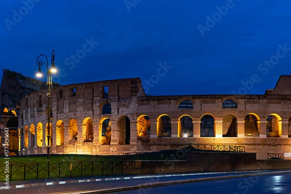 Obraz 2019-11-01 A EARLY MORNING LOOK AT THE COLOSSEUM IN ROME ITALY WITH LIGHTS PROVIDING A WARM GLOW