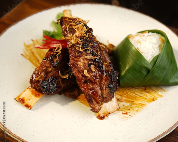Fototapeta Traditional Indonesian Grilled Chicken with Banana Leaf Rice
