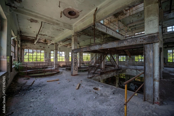 Fototapeta Abandoned distillery tower in Italy – circular industrial building with glass dome, steel beams, panoramic windows, decaying factory interior, urban exploration, post-industrial architecture