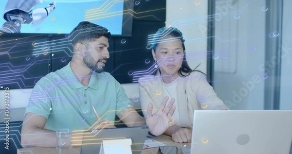 Obraz Tech professionals analyzing data using laptop in office, with stylus and robotic arm