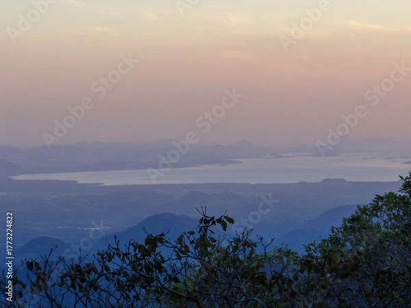 Obraz Water Body Amidst Hazy Mountains at Sunset