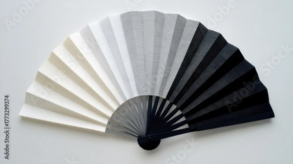Obraz An open hand fan displays alternating bands of color transitioning from white to black creating a gradient with ribs for
