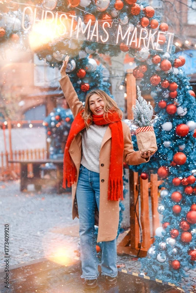 Fototapeta Celebrating joy and warmth at a festive Christmas market in winter