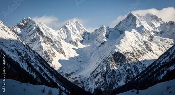 Obraz Snowy mountain peaks under a bright blue sky in a winter landscape