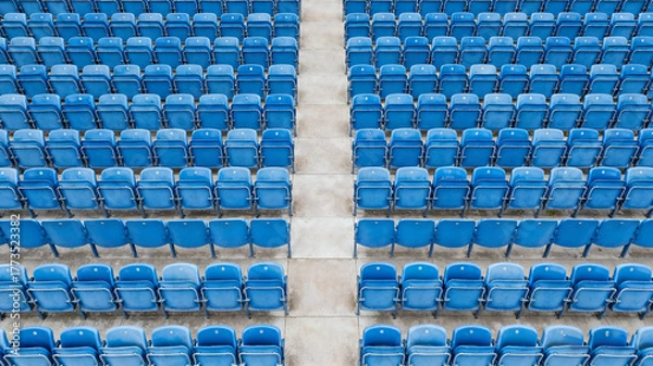 Fototapeta Symmetrical blue stadium seats from above, a serene geometric pattern of empty spaces