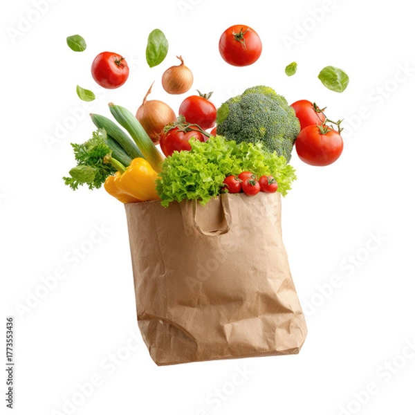 Obraz Fresh vegetables bursting from a brown paper bag against a black background