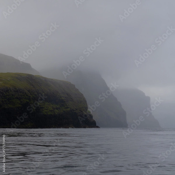 Fototapeta view of the iconic Vestmannabjorgini or Vestmanna Cliffs on Streymoy Island in the Faroe Island Archipelago on a foggy and overcast day