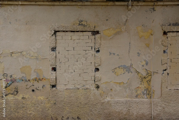 Obraz Texture of a brick wall with old, peeling paint in some partially ruined buildings