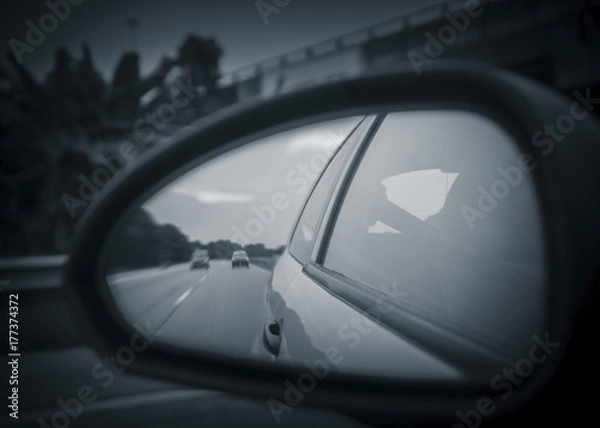 Fototapeta Unusual view of the highway from reflection on rearview