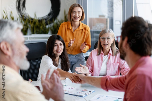 Fototapeta Diverse group of team of professionals working together on project in modern office, shake hands