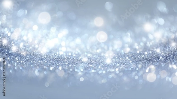 Fototapeta A beautiful abstract image featuring a silver bokeh background with shimmering light effects. Ideal for creative projects and festive occasions.