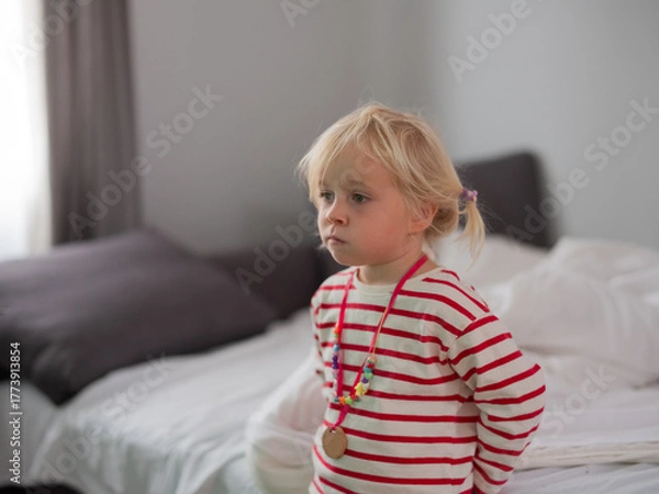 Obraz Little 4-year-old girl watching TV with fascination