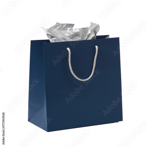 Obraz Dark blue gift bag with white rope handles and silver tissue paper on transparent background