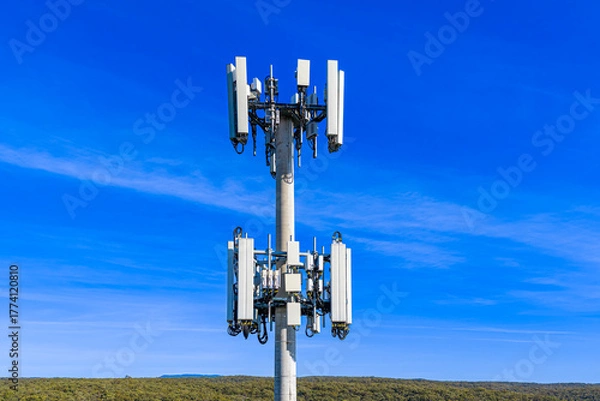 Fototapeta Drone aerial photograph of the top section of a large Cellular Tower against a bright blue sky background in the Blue Mountains, New South Wales, Australia.