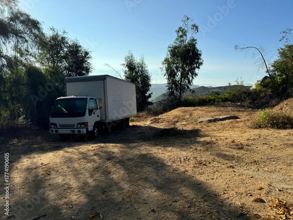 Obraz old white truck abandoned in the desert - empty, no people, nobody - dry mountain landscape with shrubs and trees - Escondido, California, USA
