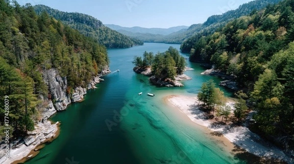 Obraz Serene Turquoise Lake Surrounded by Lush Green Forested Hills Under a Bright Blue Sky with Gentle Sunlight Filtering Through the Trees