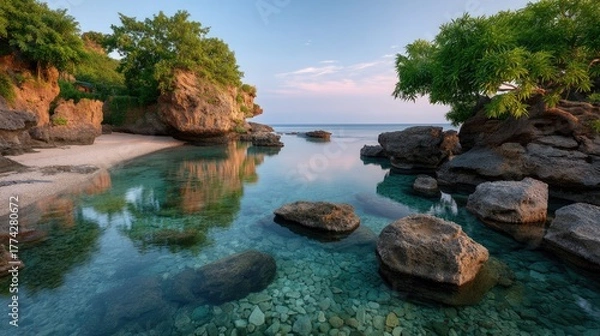 Fototapeta Tranquil Tropical Coastline at Dawn with Calm Turquoise Water and Lush Greenery Reflecting in the Serene Expanse