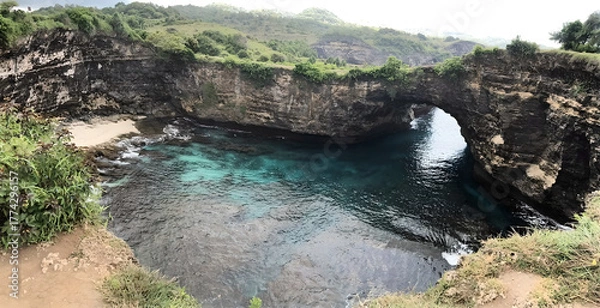 Obraz Natural Coastal Arch with Clear Blue Water and Rocky Cliffs