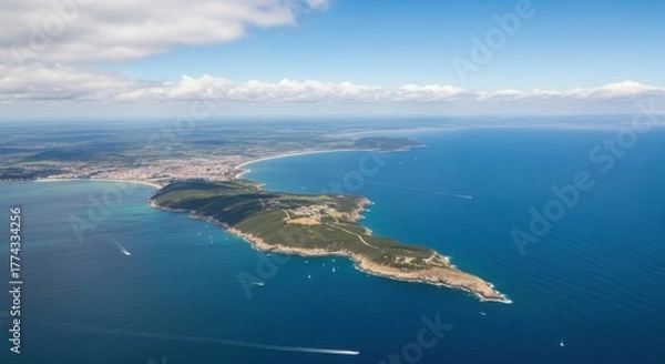 Obraz Aerial view of coastal town and verdant peninsula jutting into blue ocean