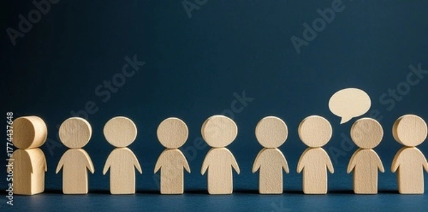 Fototapeta A group of wooden figures, one standing out with a speech bubble.