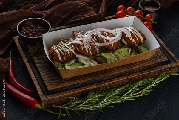 Obraz Lunchbox with falafel on a wooden tray