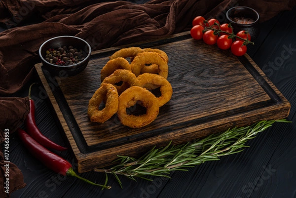 Obraz Breaded onion rings on a wooden tray