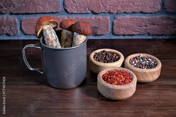 Obraz Red-Capped Scaber Stalk (Leccinum aurantiacum) Mushrooms in a Metal Mug with Wooden Bowls of Spices
