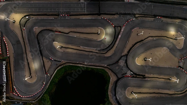 Fototapeta Aerial top view race kart track at night, Track for auto racing top view at night, Car race asphalt and curve street circuit, Aerial view asphalt race track at night.