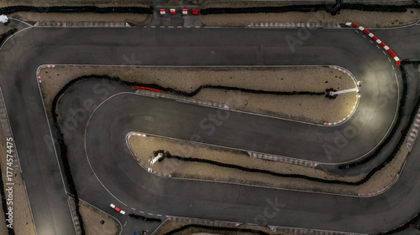Fototapeta Aerial top view race kart track at night, Track for auto racing top view at night, Car race asphalt and curve street circuit, Aerial view asphalt race track at night.