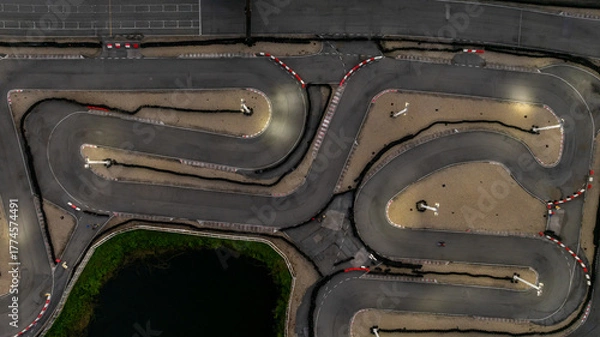 Fototapeta Aerial top view race kart track at night, Track for auto racing top view at night, Car race asphalt and curve street circuit, Aerial view asphalt race track at night.