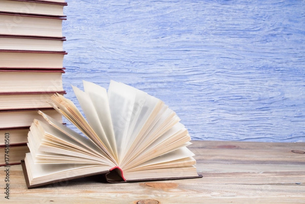 Fototapeta open book, books on the blue background. Back to school. Education. Copy space for text.