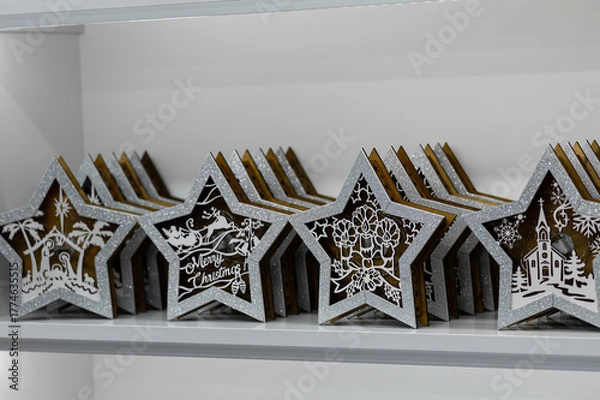 Obraz Wooden Christmas star decorations on display shelf