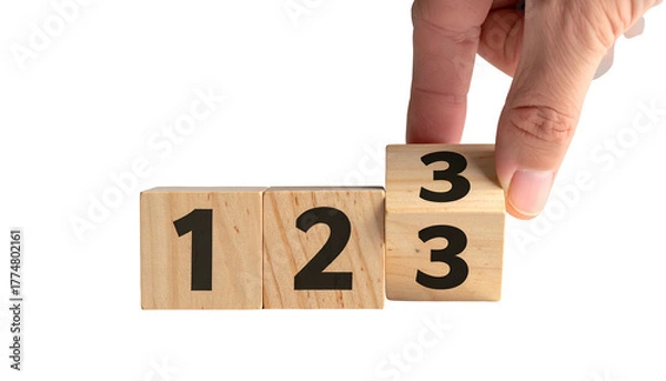 Fototapeta Hand flips a wooden block to reveal "3", creating sequence "1, 2, 3