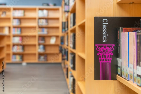 Obraz Photo of a Classics sign on a bookshelf in a library.