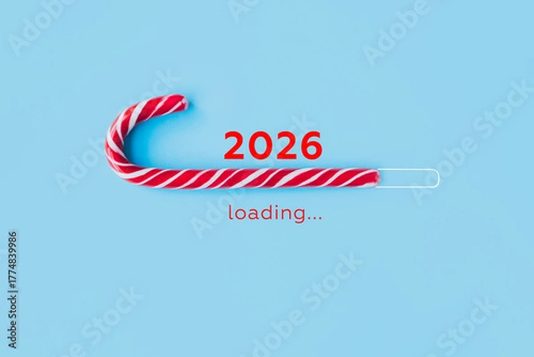 Fototapeta Striped candy cane and lettering 2026 loading on blue background. Concept of waiting for seasonal holidays