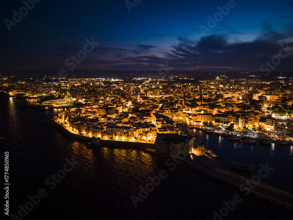 Obraz Night view of the illuminated historic center, harbor, and Carlo V Castle in Monopoli, Italy
