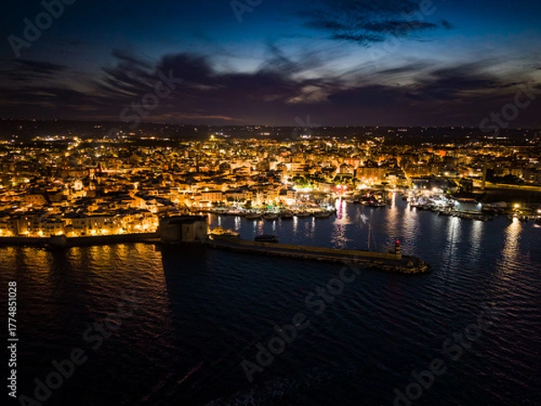 Obraz Iconic view of the illuminated historic center, harbor, and castle of Monopoli, Italy, at night