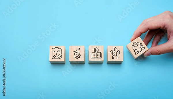 Fototapeta Change management process concept with hand arranging wooden blocks showing strategy, growth, learning, leadership, and teamwork icons, symbolizing organizational transformation, business improvement