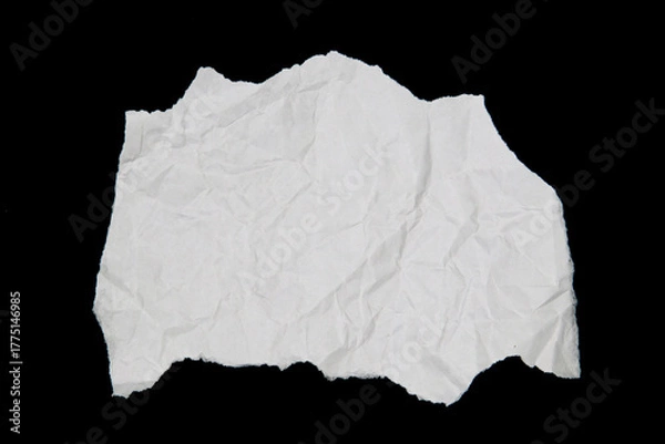 Fototapeta White paper cut with torn edges isolated on black background.