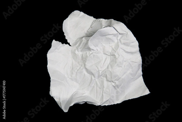 Fototapeta White paper cut with torn edges isolated on black background.